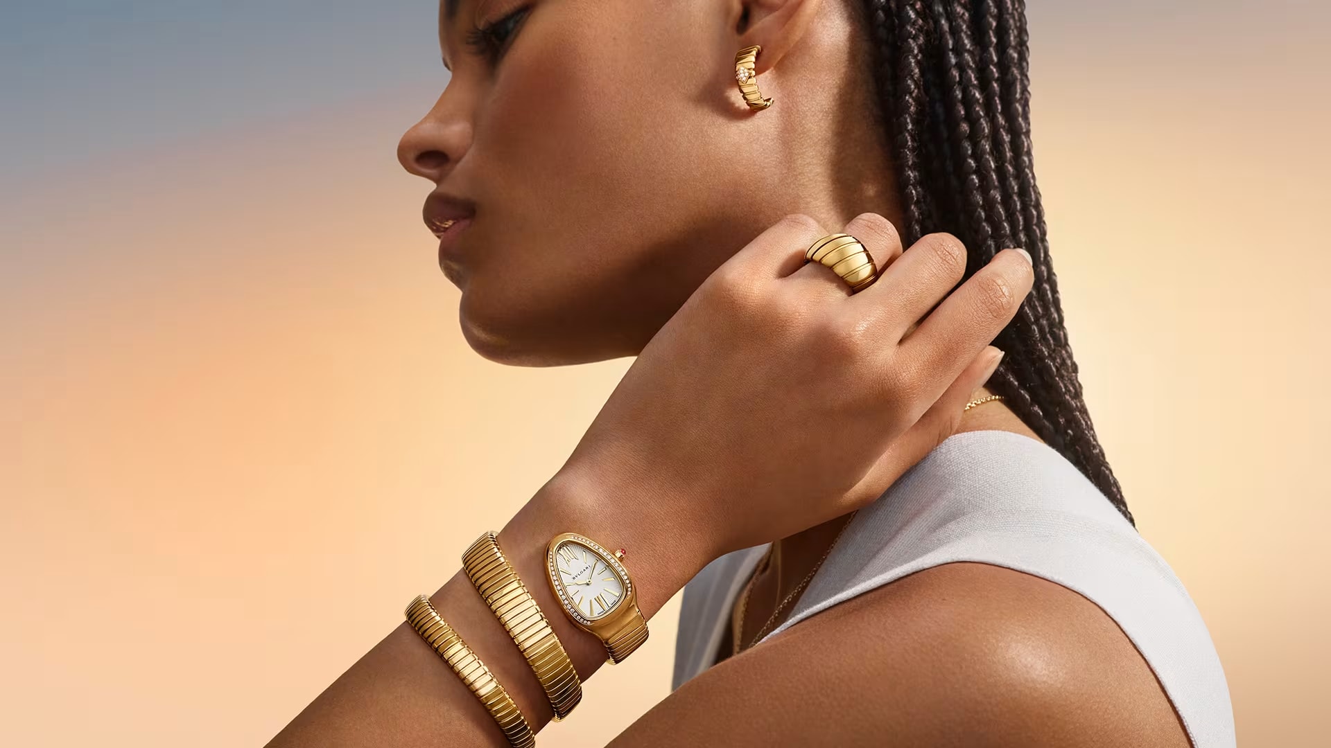Model waring Bvlgari Tubogas jewellery and Serpenti watch.