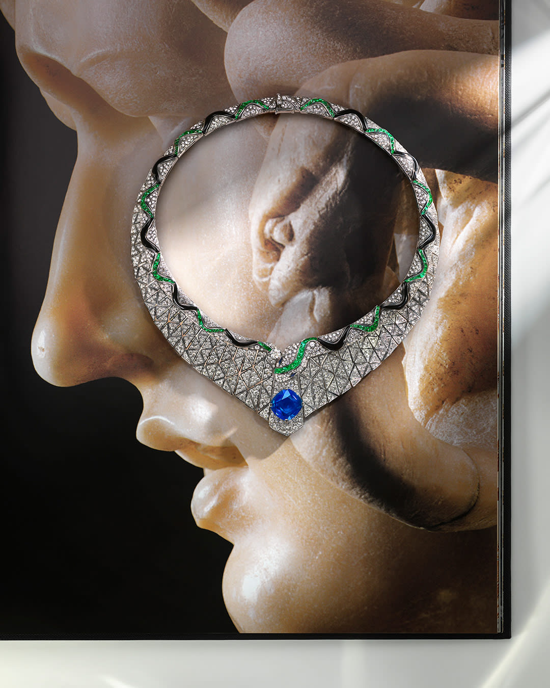 Serpenti Illusio High Jewellery white gold necklace set with a cushion sapphire, diamonds, onyx and emeralds.