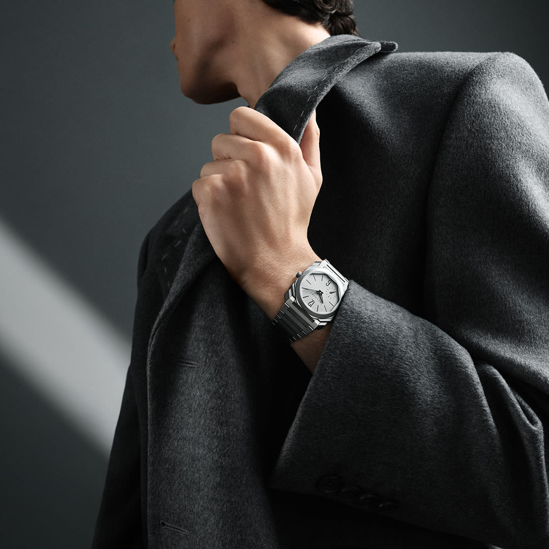 Man wearing monochromatic Octo Finissimo Automatic 37mm watch in sandblasted titanium, close-up.