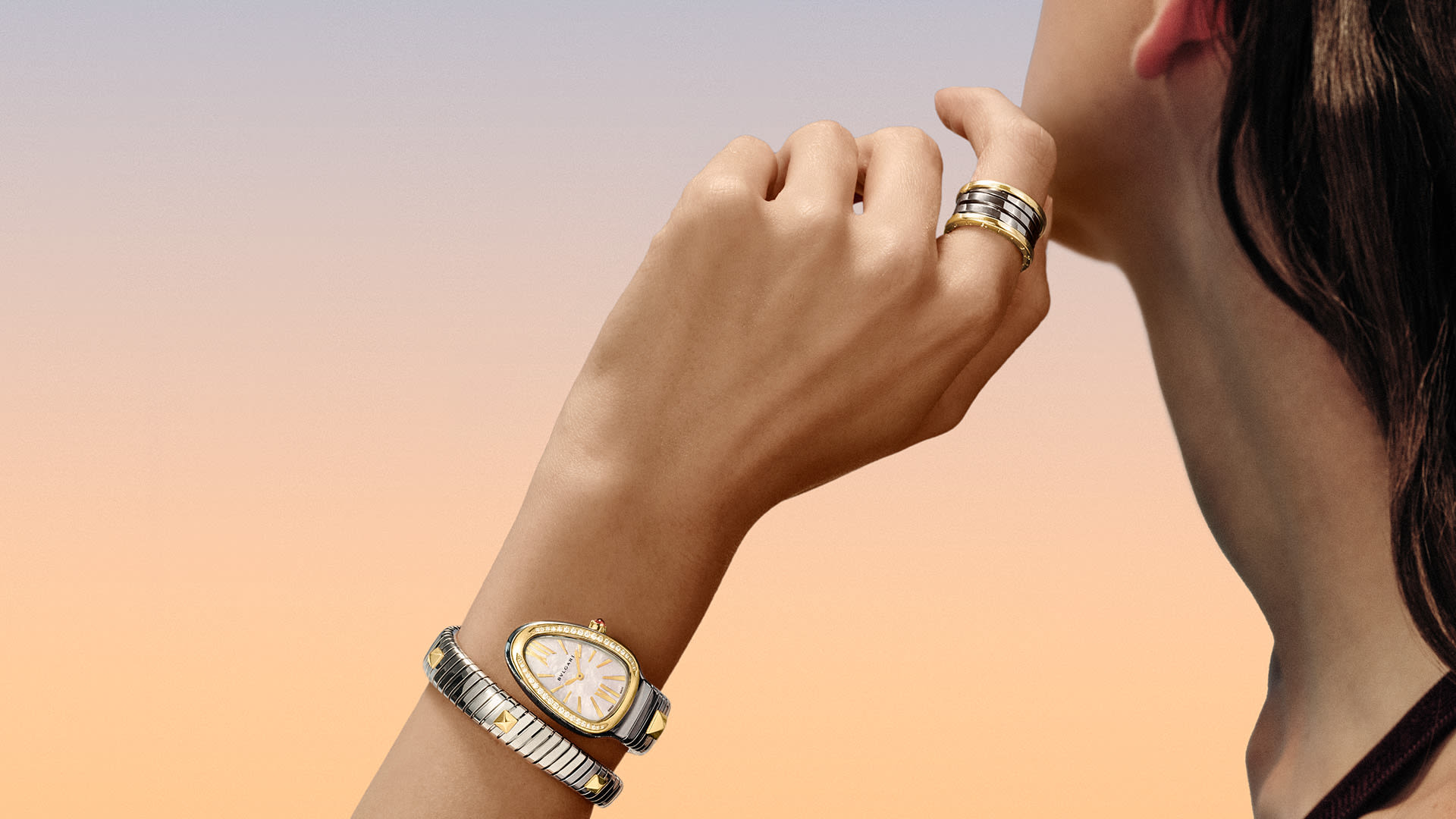 Models waring B.zero1 ring and Serpenti watch in Gold & Steel.