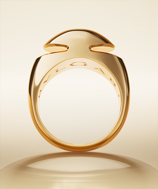Bulgari Cabochon 18 kt yellow gold ring with Bulgari logo engraving inside, neutral backdrop.